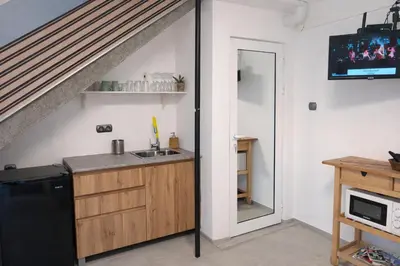 a kitchen with a sink and a staircase at Wendy House - Central Sofia - 3BRDR - Private Courtyard - 5 min to Vitosha blvd in Sofia