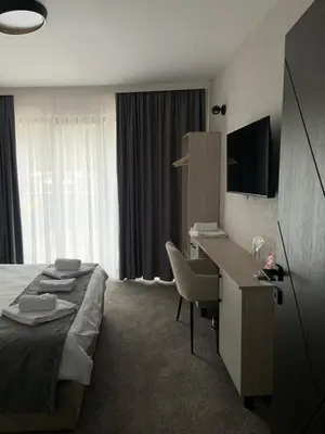 a hotel room with a bed and a desk at Zlate Home in Zlatograd