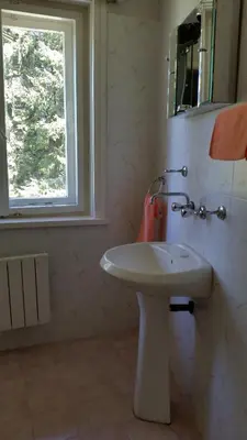 a bathroom with a white sink and a window at Boeritza Hotel Complex in Vladaya