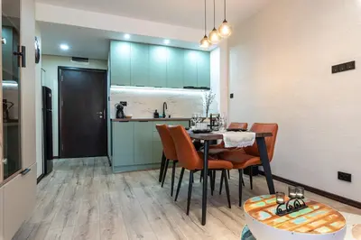 a kitchen and dining room with a table and chairs at Vutovi's corner made with care 2 in Bansko