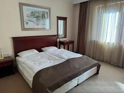 a bedroom with a large bed in a room at Downtown Bansko Resort in Bansko