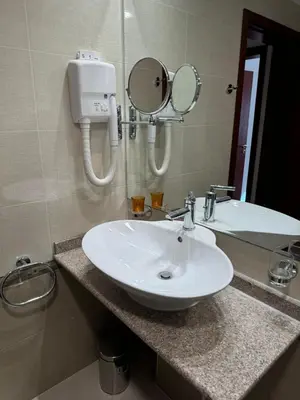 a bathroom with a white sink and a mirror at Downtown Bansko Resort in Bansko