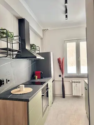 a kitchen with a black counter top and a sink at Central Luxury Stay Sofia Center by Top Kvartiri Ltd in Sofia