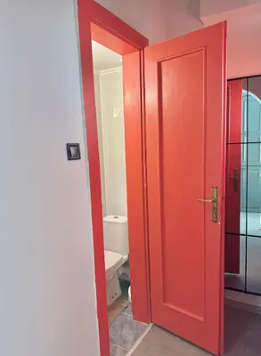 a bathroom with a red door and a toilet at Central Luxury Stay Sofia Center by Top Kvartiri Ltd in Sofia