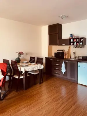a kitchen with a table and chairs in a room at Mountain View Apartment at Bansko Royal Towers in Bansko