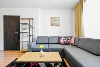 a living room with a couch and a table at BudgetWork-Friendly Apartment near Business Park in Sofia