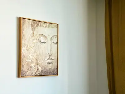 a painting of a face hanging on a wall at BudgetWork-Friendly Apartment near Business Park in Sofia