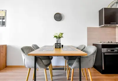a dining room with a wooden table and chairs at BudgetWork-Friendly Apartment near Business Park in Sofia