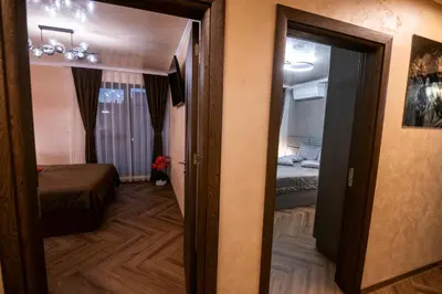 a room with a door open to a room with a bed at Luxe Apartment Pana Green Residence Panagyurishte in Panagyurishte