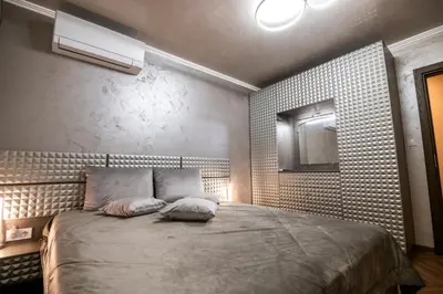 a bedroom with a bed with two pillows on it at Luxe Apartment Pana Green Residence Panagyurishte in Panagyurishte