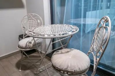 a table and two chairs and a table and a table at Luxe Apartment Pana Green Residence Panagyurishte in Panagyurishte