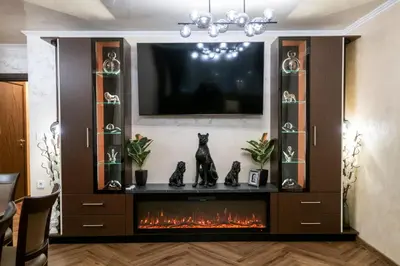a entertainment center with a fireplace in a living room at Luxe Apartment Pana Green Residence Panagyurishte in Panagyurishte