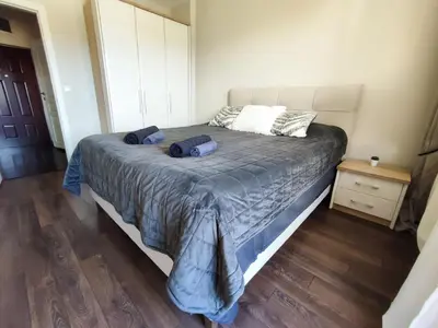 a bedroom with a bed with two pillows on it at Deluxe Apartment 