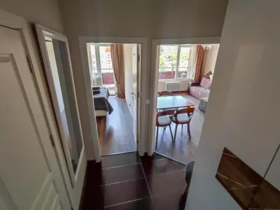 a view of a living room with a table and a couch at Deluxe Apartment 