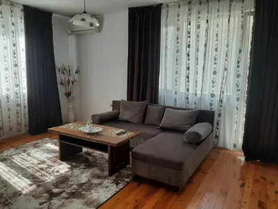 a living room with a couch and a table at Апартамент Ризови in Sandanski