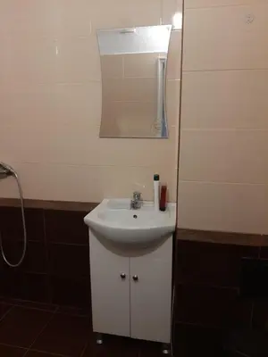 a bathroom with a white sink and a mirror at Апартамент Ризови in Sandanski