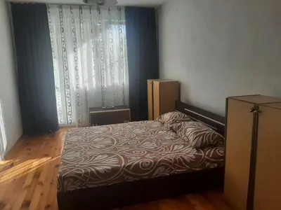 a bedroom with a bed and a window at Апартамент Ризови in Sandanski