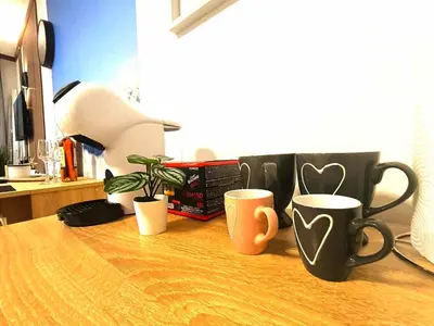three coffee cups sitting on a wooden table at Grand studio in 4star SPA resort in Bansko in Bansko