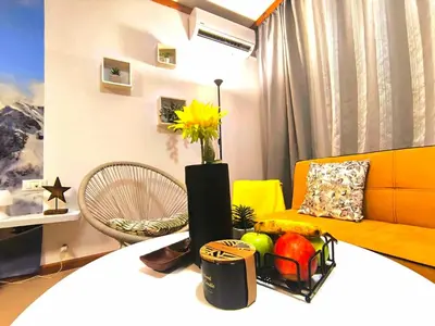 a living room with a vase of flowers on a table at Grand studio in 4star SPA resort in Bansko in Bansko