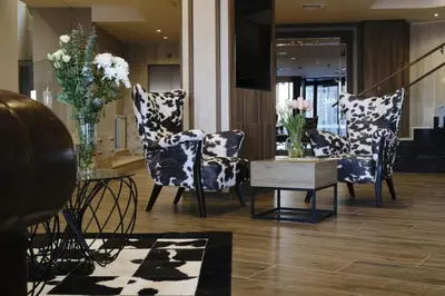 a living room with chairs and a table with flowers at Grand studio in 4star SPA resort in Bansko in Bansko