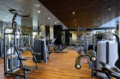 a gym with several treadmills and machines at Grand studio in 4star SPA resort in Bansko in Bansko