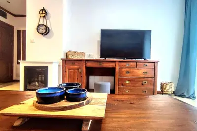 a living room with three bowls on a wooden table at Large 1bd apartment in 4star SPA resort Bansko in Bansko