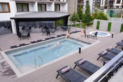 a woman is in a swimming pool in a building at Large 1bd apartment in 4star SPA resort Bansko in Bansko