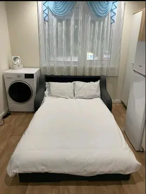 a bedroom with a white bed with a window at Лари Б01 in Borovets