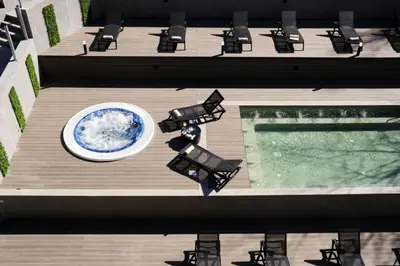 an overhead view of a deck with chairs and a pool at Comfy 1bd apartment in 4star SPA resort Bansko in Bansko