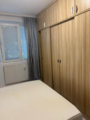 a bedroom with wooden cabinets and a bed at ApartSofiaMusagenica in Sofia