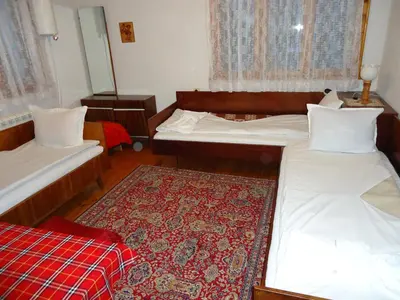 a bedroom with two beds and a rug at Guest House AHP in Mala Tsŭrkva