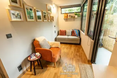 a living room with a chair and a couch at Urban Oasis Sofia in Sofia