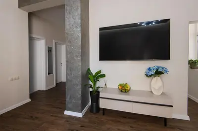 a living room with a flat screen tv on a wall at Kapana by V2 in Plovdiv