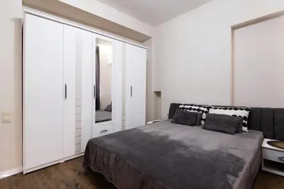 a bedroom with a large bed and a mirror at Kapana by V2 in Plovdiv