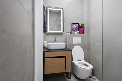 a bathroom with a sink and a toilet and a mirror at Kapana by V2 in Plovdiv