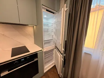 an empty refrigerator with its door open in a kitchen at Serenity Suites in Gotse Delchev