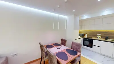 a kitchen with a table and chairs in a room at Cozy Central 1BDR Apartment Sofia near Mall Sofia and metro in Sofia