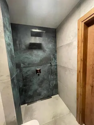 a bathroom with a shower with a hose at Stylish Sofia Getaway 1BDR near Mall Sofia and metro station in Sofia