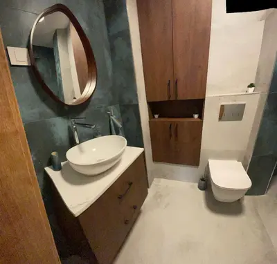 a bathroom with a sink and a mirror and a toilet at Stylish Sofia Getaway 1BDR near Mall Sofia and metro station in Sofia
