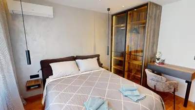 a bedroom with a bed with blue towels on it at Stylish Sofia Getaway 1BDR near Mall Sofia and metro station in Sofia