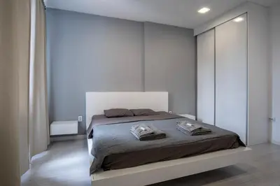 a bedroom with a large bed in a room at blueWave.place Sofia in Sofia