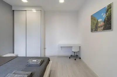 a bedroom with a bed and a desk and a table at blueWave.place Sofia in Sofia