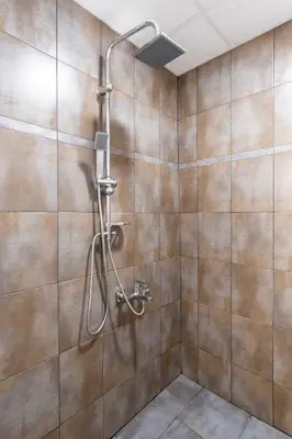 a shower with a shower head in a bathroom at blueWave.place Sofia in Sofia