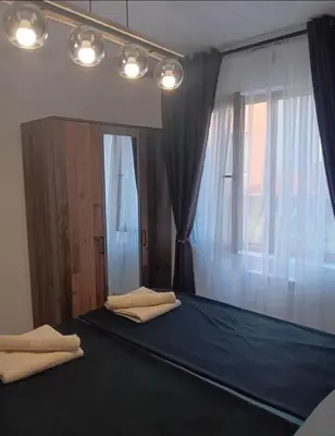 a bedroom with a bed with two pillows and a window at Double next to NBU and Merto station, free parking in Sofia