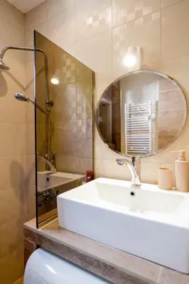 a bathroom with a sink and a mirror and a toilet at TOP central location Sophia apt in Sofia