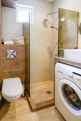 a bathroom with a toilet and a washing machine at TOP central location Sophia apt in Sofia