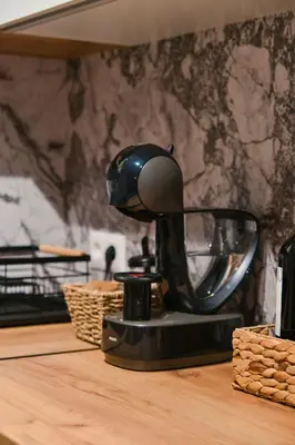 a black mixer sitting on top of a counter at Quiet & Stylish Apartment in Central Sofia in Sofia