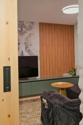 a living room with a table and a tv at Quiet & Stylish Apartment in Central Sofia in Sofia