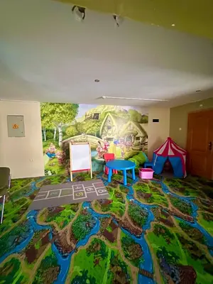 a living room with a mural on the wall at Green View Apartment in Chepelare