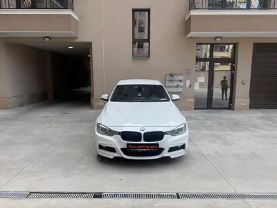 a white car parked in front of a building at Cozy place with free parking in Sofia